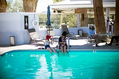 The 29 Palms Inn restaurant and grounds at the Oasis of Mara, seen from the palm-shaded interior courtyard.