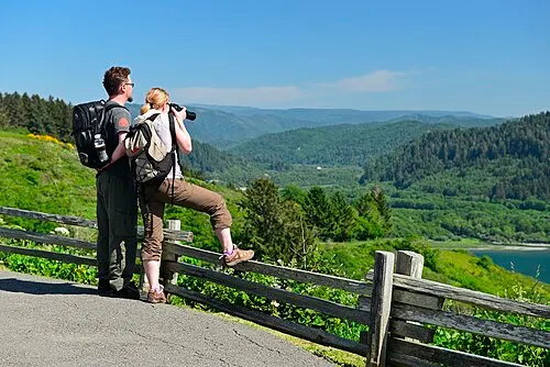 Visitors at the Klamath River Overlook bluff looking out over the river mouth and the Pacific Ocean.