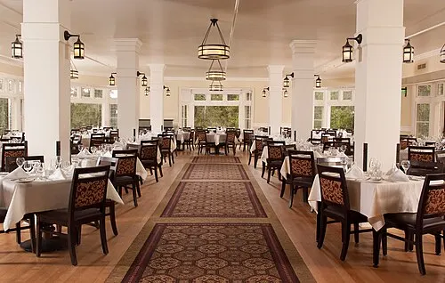 Interior of the Lake Yellowstone Hotel Dining Room with windows facing Yellowstone Lake.