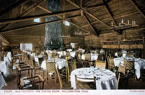 Interior of the Old Faithful Inn Dining Room with timber-framed ceiling and set tables.