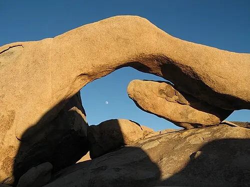 Moon hanging over Arch Rock, a wind-eroded monzogranite arch on the Arch Rock Nature Trail.