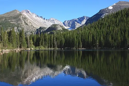 Bear Lake at 9,475 feet, ringed by conifers under the high peaks of the Continental Divide in Rocky Mountain National Park.