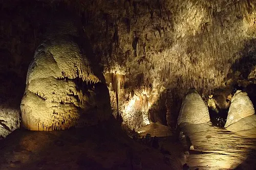 Lit limestone formations along the paved Big Room trail loop, the largest cave chamber in North America by floor area, Carlsbad Caverns.