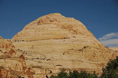 White Navajo Sandstone dome rising above the red cliffs of Capitol Reef along Utah State Route 24.