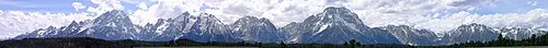The three peaks of the Cathedral Group, Grand Teton, Mount Owen, and Teewinot, rising sharply from the valley floor with no foothills.