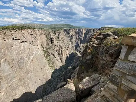 Cross-canyon view from Chasm View on the South Rim, sheer walls dropping straight to the Gunnison River.