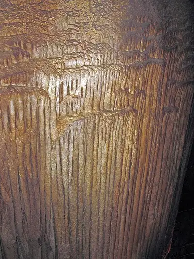 The Frozen Niagara travertine flowstone in Mammoth Cave, calcite deposits hanging like a stopped waterfall down the cave wall.