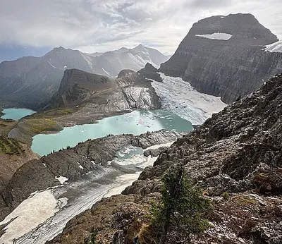 Grinnell Glacier and its meltwater lake below cliffs, with the Salamander Glacier above.