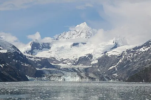 Johns Hopkins Glacier flows into its inlet with Mount Orville and Mount Wilbur of the Fairweather Range rising behind it.