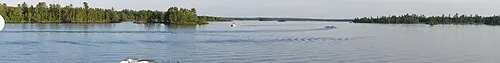 A calm bay in the boreal lake country of Voyageurs National Park ringed by spruce and pine.