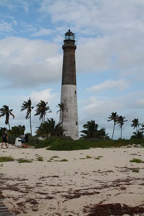Brick Loggerhead Key lighthouse rising over the low palm-dotted key, the largest island in Dry Tortugas National Park.