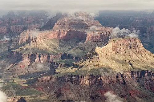 The Grand Canyon dropping away below the railed paved overlook at Mather Point on the South Rim.