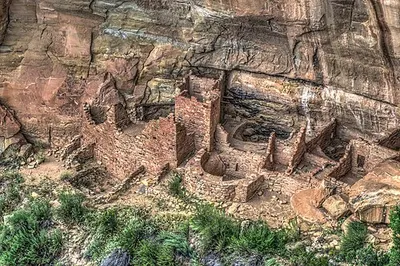 Square Tower House seen from a Mesa Top Loop overlook, a tall masonry tower set into a canyon alcove on Chapin Mesa.