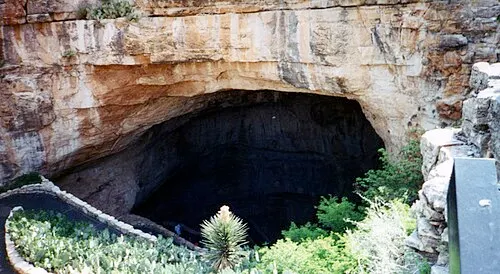 The Natural Entrance of Carlsbad Caverns, a wide rock opening with paved switchback trail descending 750 feet into the cave.