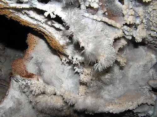 Delicate white needle-like frostwork growing on top of boxwork inside Wind Cave