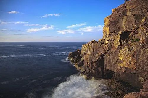 The 110-foot granite face of Otter Cliff dropping to the surf along the Park Loop Road, Acadia National Park.
