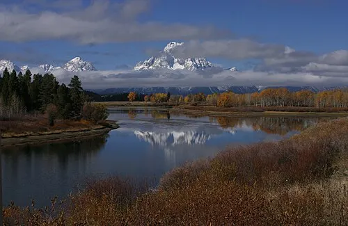 Oxbow Bend of the Snake River at first light with Mount Moran reflected in the slow water.
