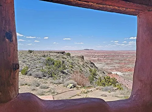 Wide view of the red and ocher Painted Desert badlands seen from the Painted Desert Inn, Petrified Forest National Park.