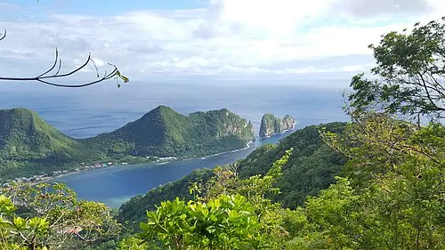 Pola Island, a tall sea-cliff islet, seen across the Vai'ava Strait from the Mount 'Alava Adventure Trail above Vatia on Tutuila.
