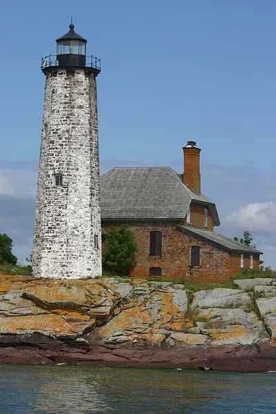 A stone lighthouse on Isle Royale above the Lake Superior shore.