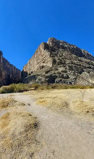 The Rio Grande flowing into Santa Elena Canyon between roughly 1,500-foot limestone walls at Big Bend National Park.