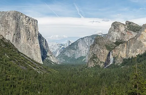 View up Yosemite Valley from Tunnel View, with El Capitan on the left, Bridalveil Fall on the right, and Half Dome at the back.