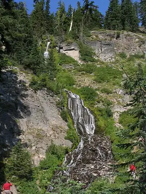 Vidae Falls cascading about one hundred feet down a rock face beside East Rim Drive at Crater Lake.