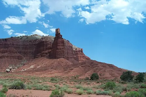 Tilted layered rock cliffs of the Waterpocket Fold monocline seen from State Route 24 in Capitol Reef National Park.
