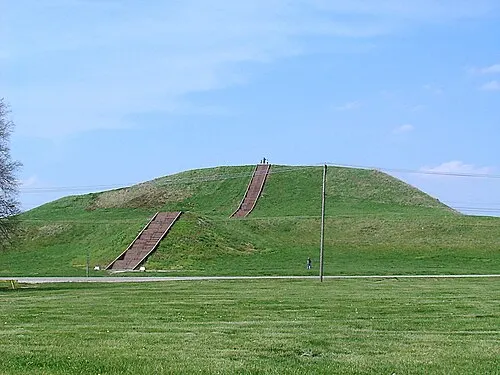 Monks Mound at Cahokia, the largest earthwork in the Americas, a broad grassed platform mound with a staircase climbing its face.