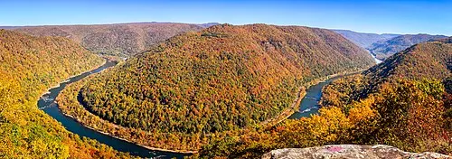 Autumn color across the New River Gorge as seen from the Canyon Rim overlook near the bridge.