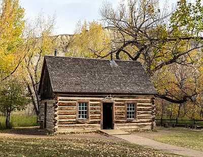 Theodore Roosevelt's 1883 Maltese Cross Cabin, a log ranch cabin beside the South Unit Visitor Center in Medora, North Dakota.