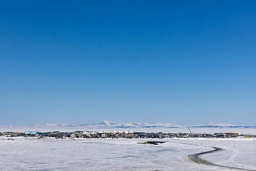 Aerial view of Qikiqtaġruk (Kotzebue) in winter — the Iñupiat town that hosts the joint NPS / BLM / USFWS Northwest Arctic Heritage Center.