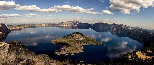 View over Crater Lake from the west rim above Rim Village, with Wizard Island in the water below.
