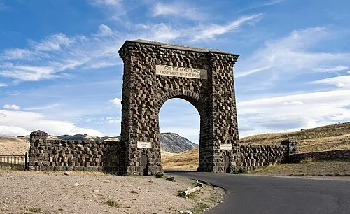Stone Roosevelt Arch at the north entrance of Yellowstone in Gardiner, Montana, with the inscription For the Benefit and Enjoyment of the People.
