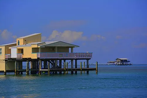A wooden house standing on stilts over the shallow flats of Biscayne Bay at Stiltsville.