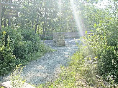 Stone-faced Duck Brook Bridge on Acadia's Rockefeller-built carriage roads, crushed gravel and car-free.