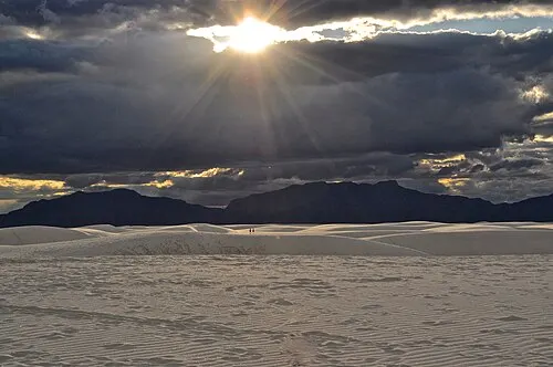 A break in the clouds over the White Sands dunes near dusk, the setting for full-moon night programs.