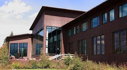Jackson Lake Lodge with its tall lobby windows facing the Teton Range across Willow Flats.