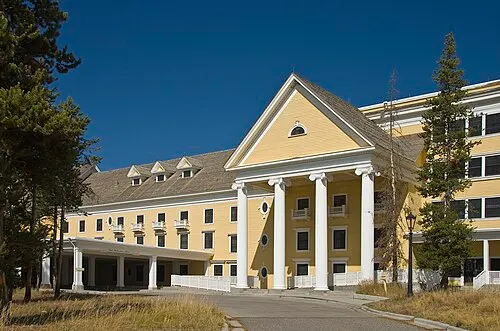Yellow Colonial Revival exterior of the Lake Yellowstone Hotel, the oldest operating hotel in any U.S. national park.