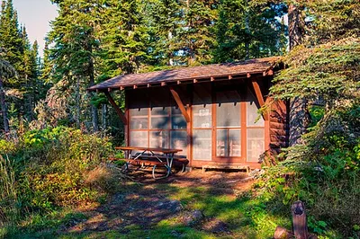 A three-sided screened wooden camping shelter at Rock Harbor Campground on Isle Royale.