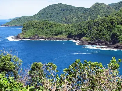 Amalu Bay coastline on Tutuila island near Pago Pago, the base for lodging on the main island (substitute; no licensed hotel image exists).