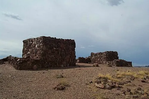 Reconstructed Ancestral Puebloan pueblo built from blocks of colorful petrified wood at Agate House, Petrified Forest National Park.