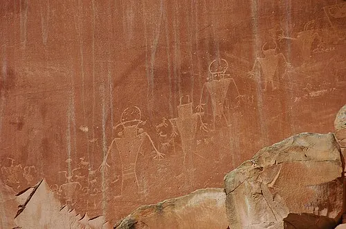 Fremont Culture petroglyphs of bighorn sheep and human figures carved into a canyon wall in Capitol Reef National Park.