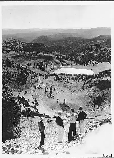 Hikers on the open switchbacks of the Lassen Peak summit trail above 9,000 feet.