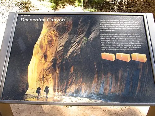A paved riverside path beside the Virgin River under the canyon walls, representative of Zion's flat, family-friendly river trails.