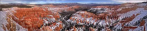 Panorama from Bryce Point looking across the full amphitheater of hoodoos toward the far rim.