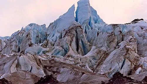 Close view of the blue ice face of Exit Glacier from the ground-level overlook.