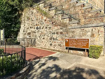 The brick Grand Promenade walkway on the hillside behind Bathhouse Row.