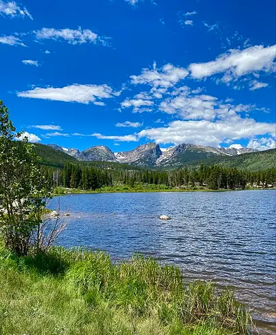 Sprague Lake reflecting the Continental Divide, ringed by a flat accessible 0.8-mile loop on Bear Lake Road.