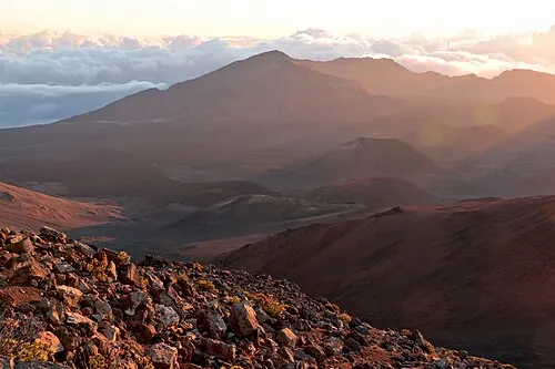 Dawn light over the Haleakalā summit, the gathering point for the reservation-only sunrise window.